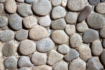 Fototapeta na wymiar Wall background, round pebbles, like a wall.