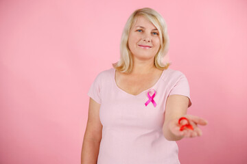 Pink October Breast Cancer Awareness month, woman hand hold pink Ribbon and wear shirt for support people life and illness. National cancer survivors month, Mother and World cancer day concept