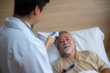 Obraz premium Asian elderly senior male depressed grandpa at hospital or nursing home living room on quarantine in mental health care concept, mental health insurance business concept