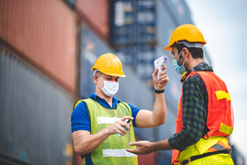 staff are checking a fever of logistic worker at container industry and cargo port, engineer and foreman, export, working in business shipping industrial, coronavirus protection process