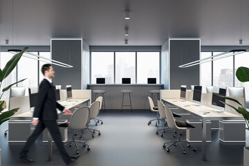 Fototapeta na wymiar Blurry european businessman walking in modern concrete coworking office interior with window and city view, daylight, furniture and equipment.