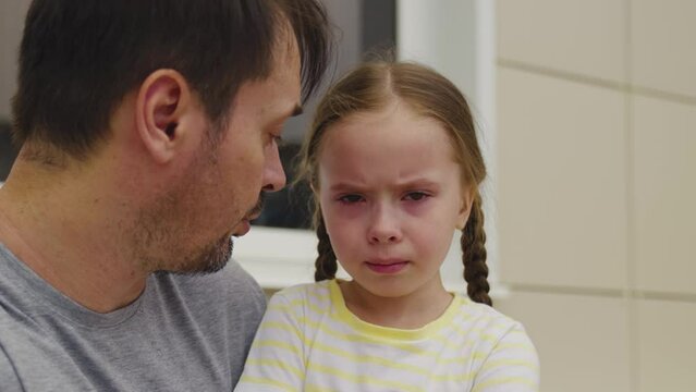 little girl crying. child does not listen dad. conflict between father kid daughter. tears upset child. bad emotions capricious kid. scandal between parent child outdoors. defend your child opinion.