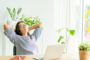 Asia woman touching massage stiff neck after sedentary computer work in incorrect posture