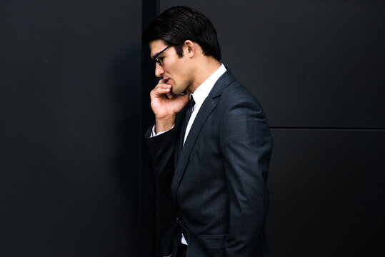Young handsome man with business suit talking at cell phone - Corporate businessman portrait, concepts about business, technology, mobility and lifestyle