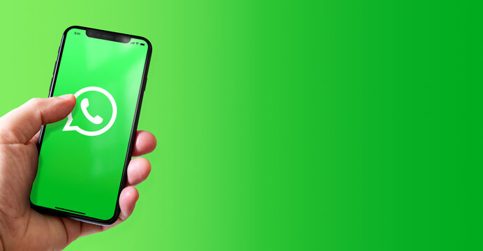 Hand holding iphone smartphone with WhatsApp logo, Paris, France