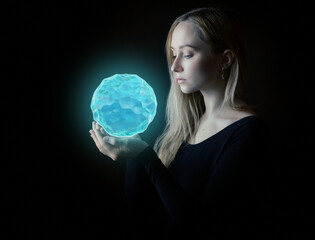 Young woman looking into blue crystal.