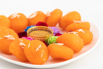 Indian Bengali Mithai Orange Kheer Mohan Also Called Khira Mohan, Santre Ki Kheer, Or Santra Khir Mohan Is Orange Color Softball made of Chena Balls, Paneer, Doodh, Panir, Chhena Soaked In Sugar Syrup