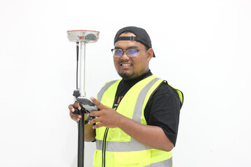 An asian male land surveyor operates a GNSS tool that is used to measure land with a satellite system.