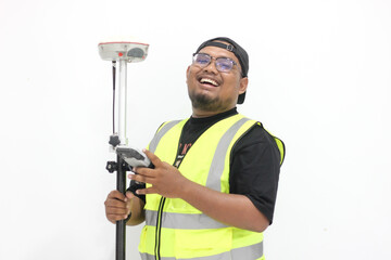 An asian male land surveyor operates a GNSS tool that is used to measure land with a satellite...