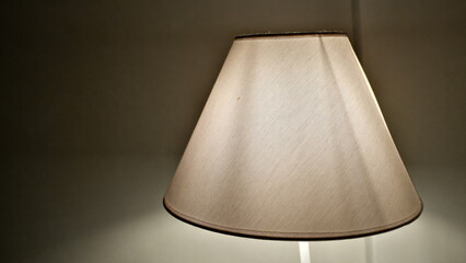 lamp on the table , dim ambient background . 
