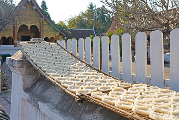 Sticky rice cakes drying outdoors, Luang Prabang, Laos 