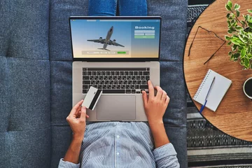 Online booking and buying plane tickets using computer and credit card © Goffkein
