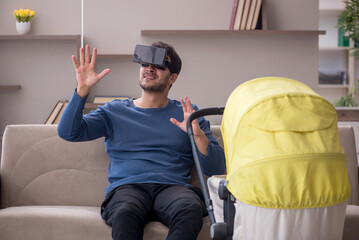 Young male contractor looking after baby at home