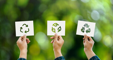 Hand holding recycle symbol 3 different icons on green bokeh background. eco concept and save the...