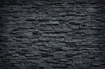 Surface black wall of stone wall gray tones for use as background. pattern of decorative stone wall surface.