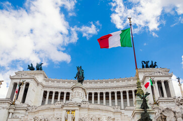 Obraz premium Italian flag on Vittoriano building. Rome, Italy. This monument is landmark of Italy.