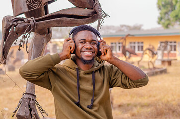 Active healthy happy African American runner, listening to music with headphones,