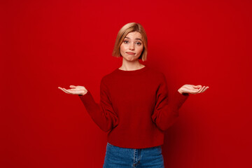 Young blonde woman expressing disappointment while throwing hands aside