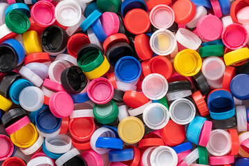 Background of plastic bottle caps. Material of the caps is recyclable. Sorting and recycling of plastic material. Environmental concept