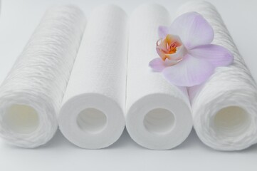 Cartridges for water treatment systems on white background.