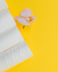 Water filters. Carbon cartridges and a glass on a yellow background. Household filtration system