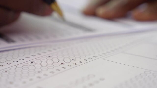 hand of young black man fills out a a multi choice test