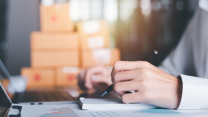 Fototapeta premium Startup or small business entrepreneur,Make a note of the delivery address from the customer,order management in online stores, shopping on the internet,Selling online on the Internet,SME,e-commerce