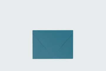 Green envelope on a blue background. Selective focus.