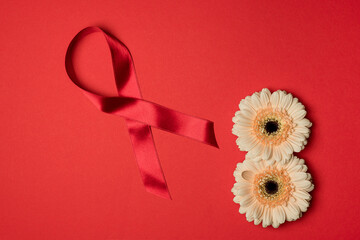 Red Ribbon for supporting people living and illness. Healthcare and safe sex concept. December World Aids Day and multiple myeloma Cancer Awareness month.