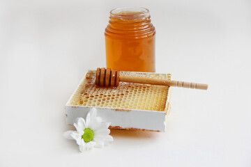 Jars of honey. Honey in honeycombs with a wooden spoon for honey.