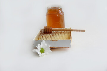 Jars of honey. Honey in honeycombs with a wooden spoon for honey.