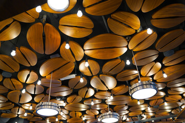 the ceiling of a cafe. ceiling with wooden shapes imitating coffee beans. detail.