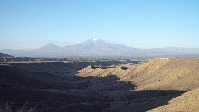 View on Ararat mountain. Time lapse cloud's shadow on mountain. Big and small Masis on blue background. 