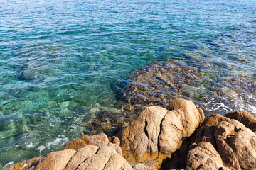 Clear turquoise water of Mediterranean sea and coastal rocks at Sardinia, Italy.