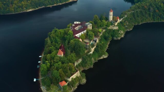 Zoom out of medieval Zvikov castle with traditional red roofs, river and forest in South Bohemia region in Czech Republic