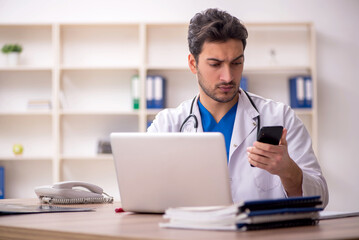 Young male doctor in telemedicine concept