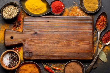Empty cutting board over various spices