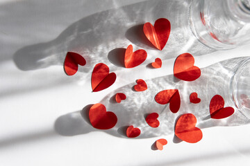 background for valentine's day. red paper hearts with beautiful shadow and light. flat lay