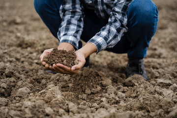 Soil in the hands of farmers. Concept of agriculture.