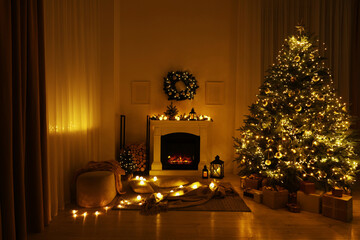 Beautiful living room interior with burning fireplace and Christmas tree in evening