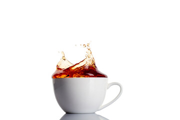 Close up image with cup of tea with splashes.