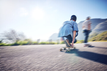 Speed, fast and men skateboarding in the street for adventure, training and exercise in Philippines. Fitness, sport and friends in motion, moving and travel in the road on a skateboard in summer
