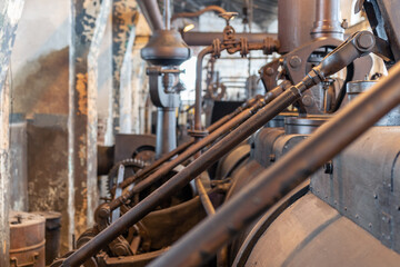 Detail of steam engine from 1903. Important part of technological line in historical factory. Metal...