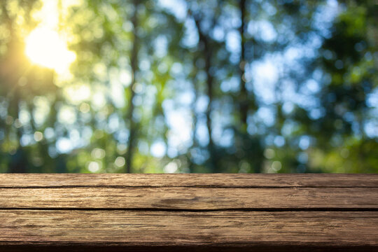 wooden table with forest bokeh background