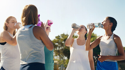 Athletic woman, friends and drinking water for hydration during sports workout, training or...