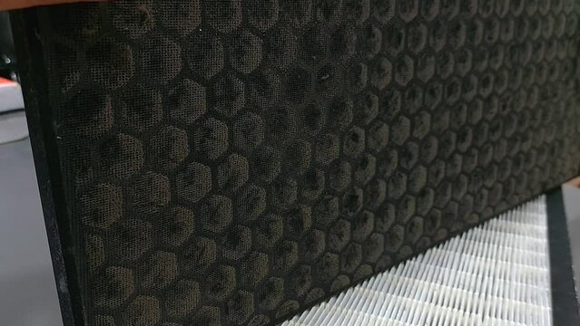 Dirty mini pleated HEPA filter, one of air purifier component to trap dust, bacteria, virus, and pollutants in the air