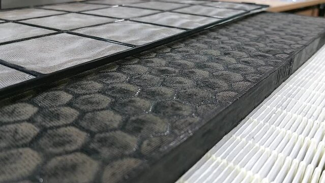 Dirty mini pleated HEPA filter, one of air purifier component to trap dust, bacteria, virus, and pollutants in the air