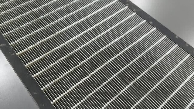 Dirty mini pleated HEPA filter, one of air purifier component to trap dust, bacteria, virus, and pollutants in the air