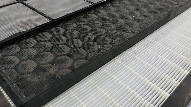 Dirty mini pleated HEPA filter, one of air purifier component to trap dust, bacteria, virus, and pollutants in the air