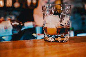 woman hand bartender making negroni cocktail. Negroni classic cocktail and gin short drink with sweet vermouth, red bitter liqueur in bar